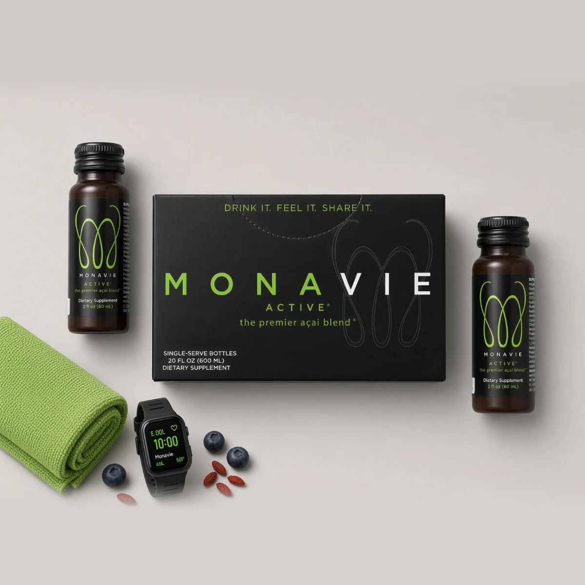 Monavie Active Shots box and bottles with a towel and a watch